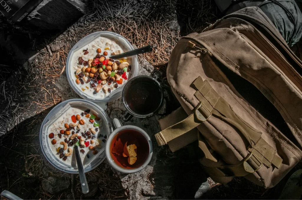 Camping food setup outdoors on a wooden table at a campsite